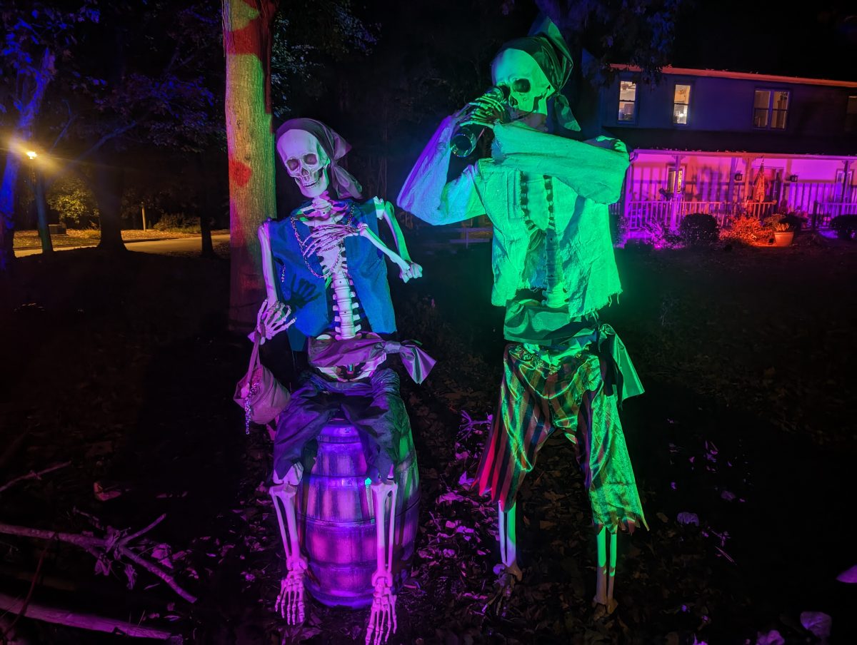 Two skeleton pirates by a barrel, one drinking from a bottle