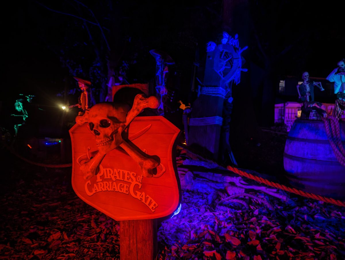 The Pirates of Carriage Gate sign with skull and crossbones, lit red